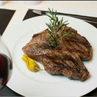 Costilla de Lomo · 32 oz. porterhouse grilled to choice. Served with salsa criolla and chimichurri.
