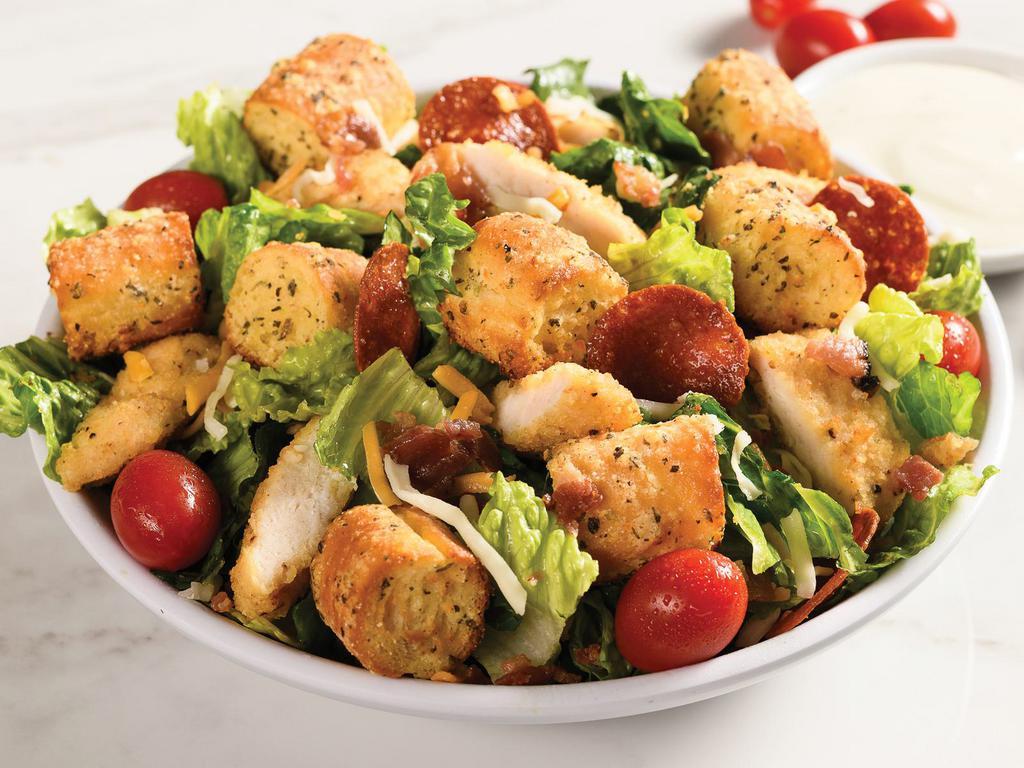 Crispy Chicken Bacon Ranch Salad · Romaine, breaded chicken, bacon, pepperoni chips, breadstick croutons, grape tomatoes, shredded mozzarella and cheddar, ranch dressing. Made fresh to order.