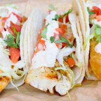 Cajun Mahi Taco · Baja style fish taco, served on corn tortillas and topped with shredded cabbage, pico de gal...