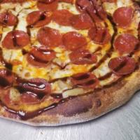 Sweet Pepperoni Pizza · Pepperoni, sweet pineapple tidbits under mozzarella drizzled with balsamic glaze.