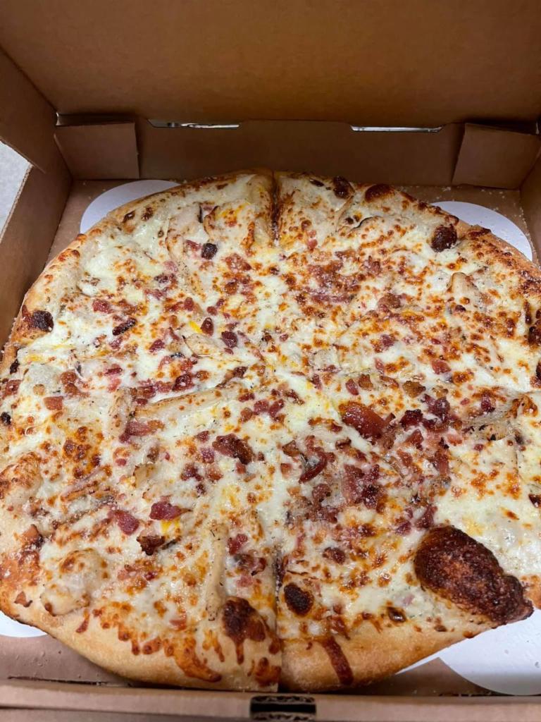 Chicken Ranch Pizza · Grilled chicken on a bed of homemade ranch dressing, covered in 3 cheese blend with a little bacon.