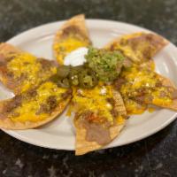 Nachos · Tortilla chips topped with your choice of meat, refried beans, cheddar cheese jalapenos, sou...