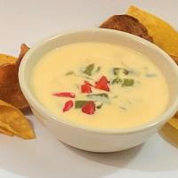 Queso Blanco · Our signature white queso simmered with onion and roasted poblanos.