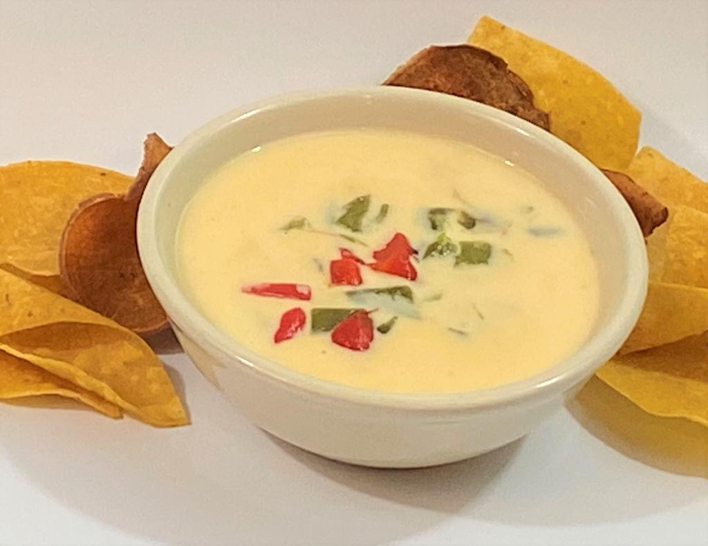 Queso Blanco · Our signature white queso simmered with onion and roasted poblanos.