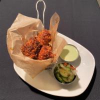 Red Hot Chicken Nuggets  · Crispy fried chicken tossed in our signature hot oil and spice rub. Served with poblano ranc...
