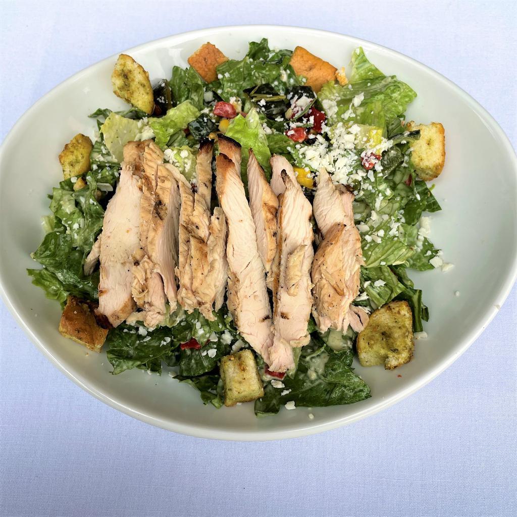Southwest Chicken Caeser Salad · Romaine lettuce, grilled corn, roasted peppers, garlic-parmesan croutons, cotija cheese and SW Caesar dressing topped with grilled chicken.