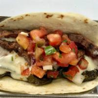 Steak Poblano Taco  · Two Tacos – grilled skirt steak, roasted poblano, queso & pico. Served with coconut lime ric...
