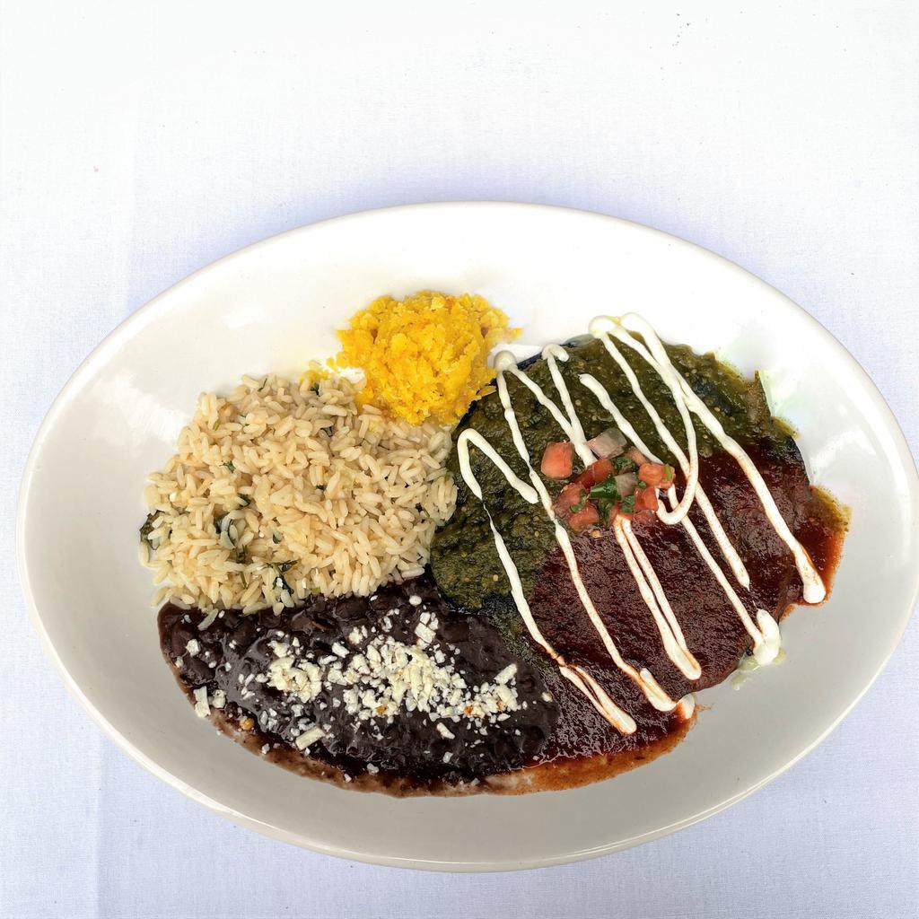 NEW MEXICO STYLE PULLED CHICKEN STACK ENCHILADA · Shredded chicken and jack cheese layered between corn tortillas. Topped with tomatillo and 3-red chile sauce with a drizzle of lime sour cream and pico de gallo. Served with coconut lime rice, smoky black beans and sweet corn cake
