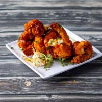 Buffalo Shrimp · Tossed in our signature Buffalo sauce and served with blue cheese dressing.