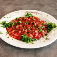 Turkish Salad · Chopped tomatoes, onions, mint, red pepper and parsley.