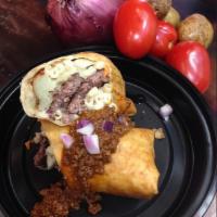 Garbage Burrito · Cheeseburger, macaroni salad and smashed potatoes rolled together, then fried and topped wit...