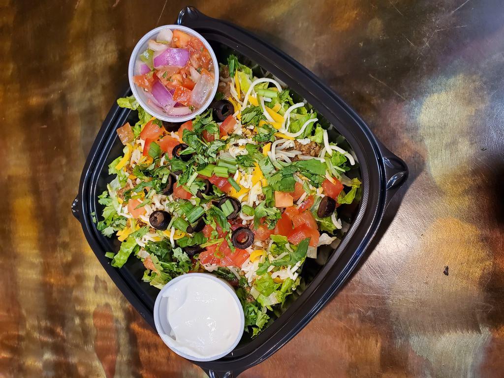 Jose's Taco Salad · Shredded lettuce on a bed of crispy tortilla bits topped with taco meat, 3 cheeses, tomatoes, scallions, olives, salsa, cilantro and sour cream.