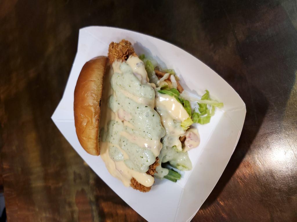 Nacho Crusted Chicken Sandwich · Nacho crusted chicken on a brioche roll topped with nacho cheese sauce, lettuce, tomatoes and our homemade avocado cream.