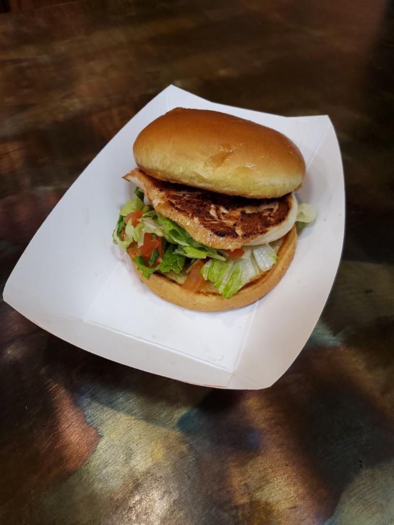 Marinated Chicken Sandwich · Marinated chicken grilled and served simply with lettuce and tomatoes on a buttery brioche roll.