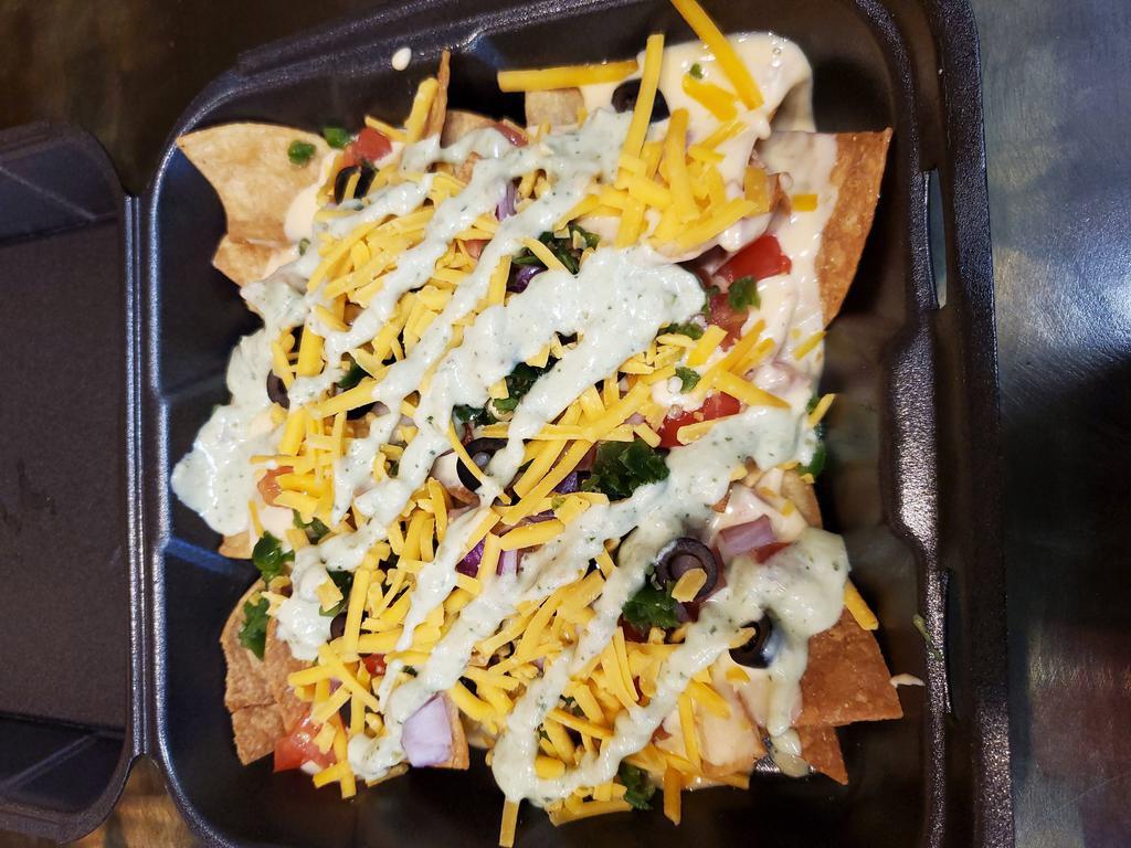 Jose’s Nachos · Homemade tortilla chips with our signature cheese sauce, tomatoes, onions, olives, jalapenos with our homemade avocado cream and cheddar cheese sprinkled on top. Add chicken, beef, pork, or steak for an additional charge.