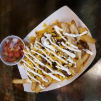 Taco Fries · French fries topped with our taco beef and nacho cheese sauce with a drizzle of sour cream a...