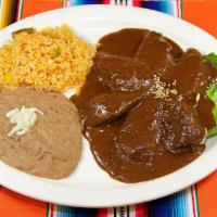 Mole Poblano Dinner · Chicken breast in brown mole sauce, rice, beans and corn tortillas.
