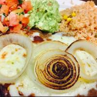 Steak Campesino · Grilled steak with refried beans, grilled onions, melted cheese on top. Served with guacamol...