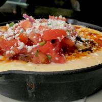 Cast Iron Queso · Beef, chihuahua, queso fresco, cheddar, pico, house made tortilla chips, house red salsa on ...