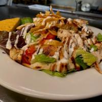 Southwest Chicken Salad · grilled chicken, tortilla strips, roasted corn and black bean salsa, cheddar-jack, pico de g...