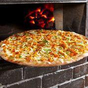 Buffalo Chicken Pizza · Our coal brick-oven pizza crust topped with fire-braised chicken breast, spicy Frank’s red hot sauce, mozzarella, Gorgonzola crumbles, and celery.