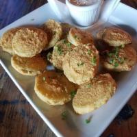 Fried Pickles · Breaded, fried and slightly spicy pickle chips topped with scallions and served with a cream...