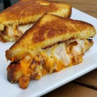 Chorizo Grilled Cheese · Fresh chorizo sausage, cheddar and pepper jack cheese, onions, sourdough bread, and fries.