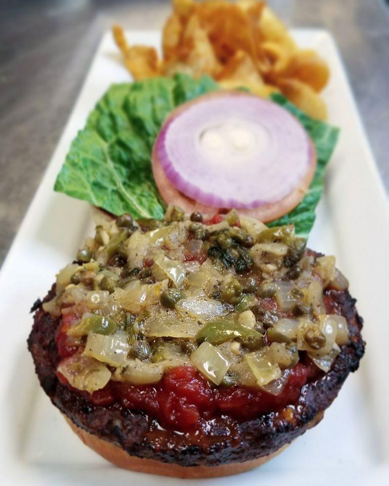 Black Bean Veggie Burger · Topped with 2 sauces, smoked tomato salsa, and jalapeno, garlic, basil, fried caper, and cilantro spread, served on a buttered bun with lettuce, tomato, onion, and fries.
