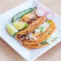 Tacos de Barbacoa · Corn tortilla filled with our special seasoned barbacoa beef, onion, cilantro, grilled onion...