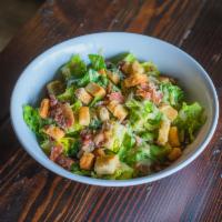 Caesar Salad · Romaine lettuce, shaved Parmesan, croutons, bacon and Caesar dressing.