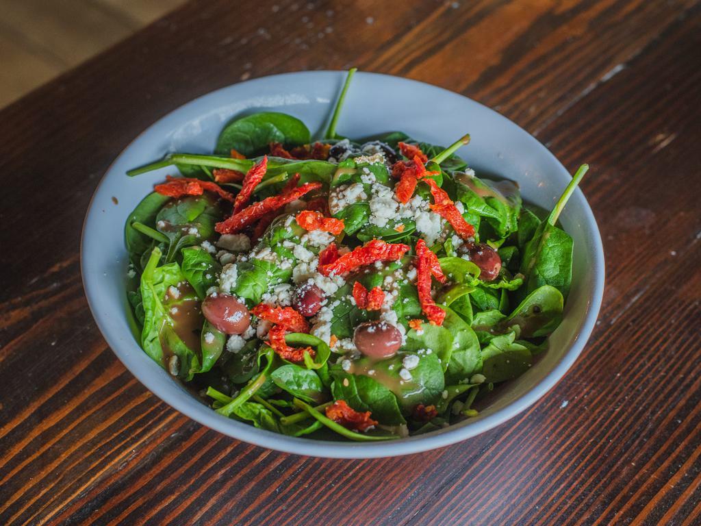 Greek Salad · Spinach, feta, Kalamata olives, sun dried tomato and balsamic dressing.