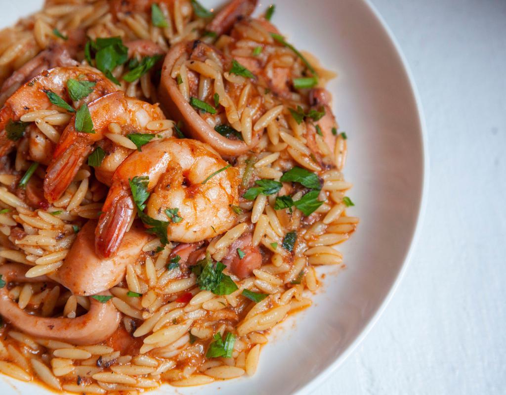 Youvetsi Thalassina  · Calamari, shrimp and octopus with herbs and orzo in fresh tomato sauce