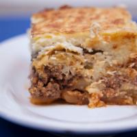 Moussakas · Traditional Greek casserole with bechamel sauce, ground beef, eggplant and potatoes.