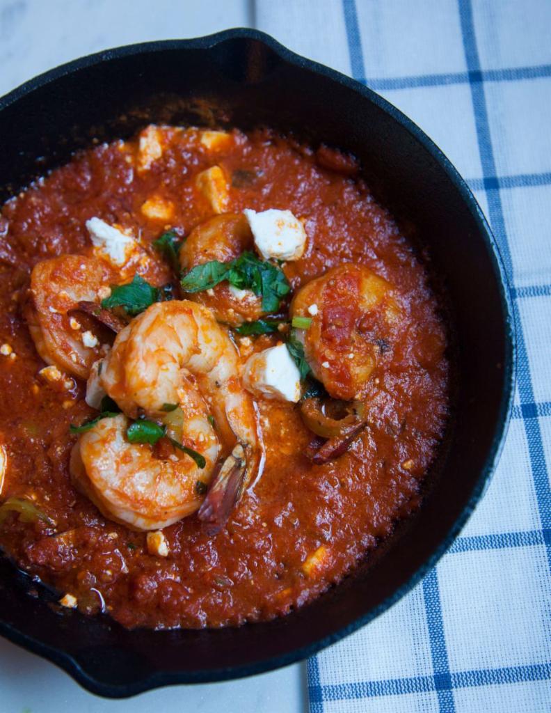 Garides Saganaki · Sauteed shrimp, cooked with feta cheese, red tomato sauce and ouzo.