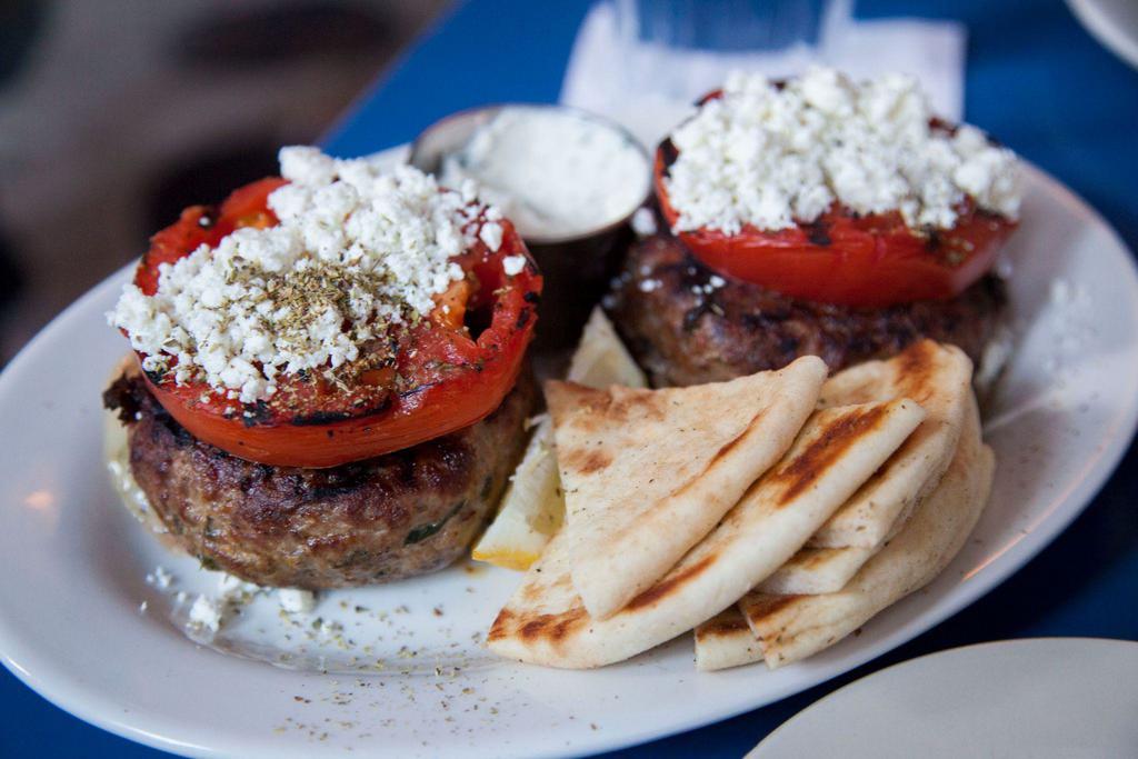 Bifteki Gemisto · Beef burger, stuffed with Greek cheeses, scallion and dill.