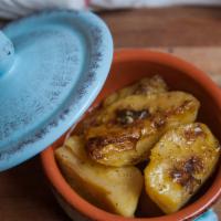 Lemonates Patates · Traditional Greek roasted lemon potatoes with oregano and olive oil.