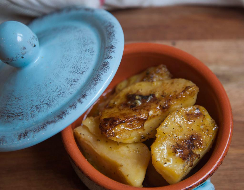 Lemonates Patates · Traditional Greek roasted lemon potatoes with oregano and olive oil.