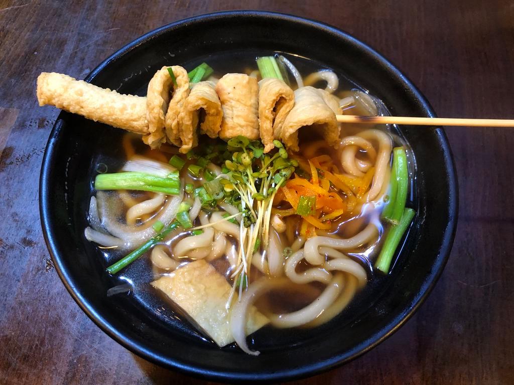 Udon · Udon noodle with fishcake, onion, green onion, pickle radish, and seaweed in soy broth.