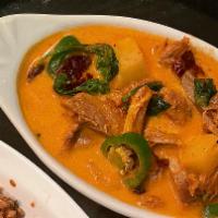 Duck Curry · Sliced duck meat in red curry with tomatoes, pineapple, Jalapeño, and basil leaves. (spicy)