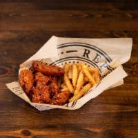 Chicken Wings Basket · 6 wings lightly battered and fried to perfection with signature crinkle cut fries and ranch ...