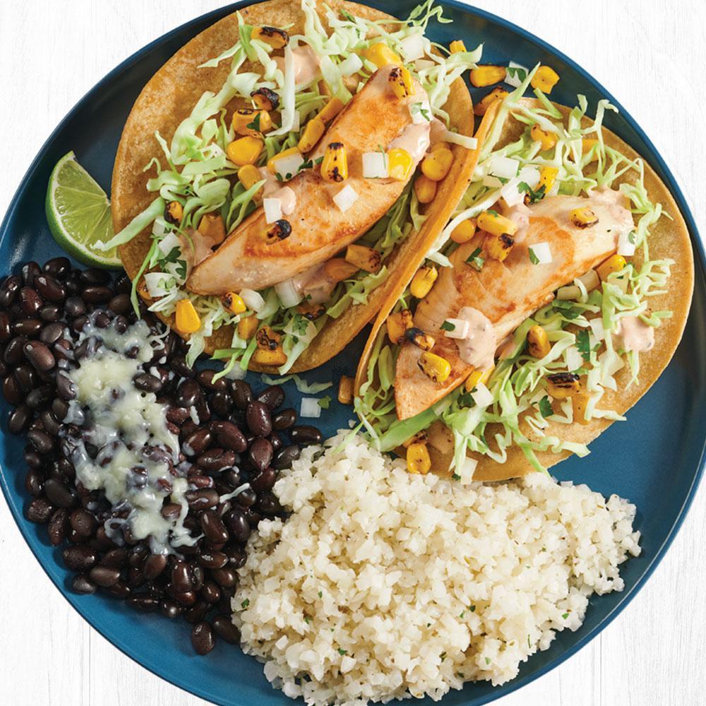Wild-Caught Mahi Mahi Two Taco Plate · Wild-Caught Mahi Mahi served on corn tortillas with fire-roasted corn, creamy chipotle sauce, cilantro/onion mix and cabbage. Served with cauliflower rice and black beans.