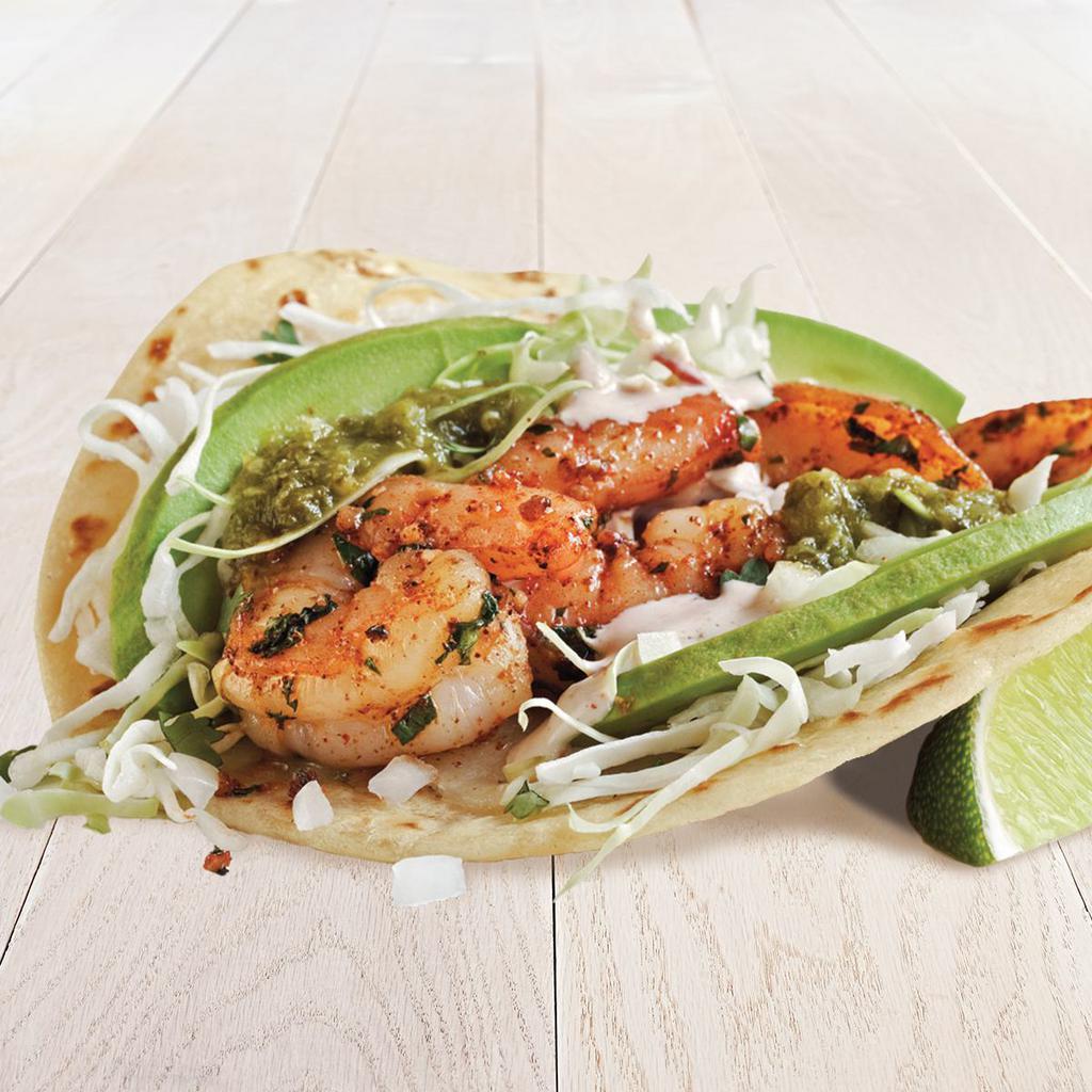 Salsa Verde Shrimp Two Taco Plate · Two tacos made with sliced avocado, cheese, creamy chipotle sauce, cilantro, onion and cabbage on a flour tortilla. Served on stone-ground corn tortillas with 