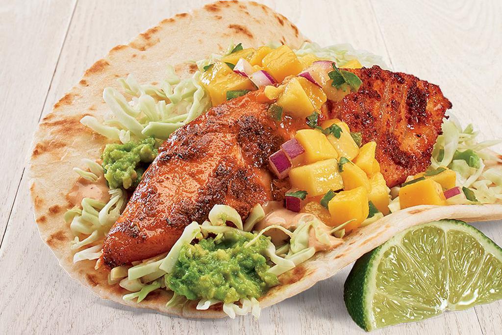 Mango Wild Mahi Mahi Two Taco Plate · Two tacos made with mango salsa, fresh guacamole, cabbage, and chipotle sauce. Served on flour tortillas with no-fried pinto beans and tortilla chips.