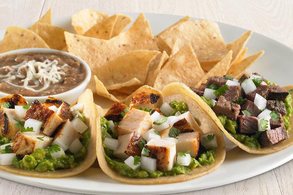 Rubio's Three Street Taco Plate® · All natural chicken or all natural steak. On street-sized tortillas with fresh guacamole and cilantro and onion. Served on stone-ground stone tortillas with your choice of two sides.  