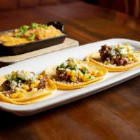 Smoked Brisket Tacos · Smoked brisket, cilantro, onion, roasted corn and Jack cheese. Include Spanish rice and refr...