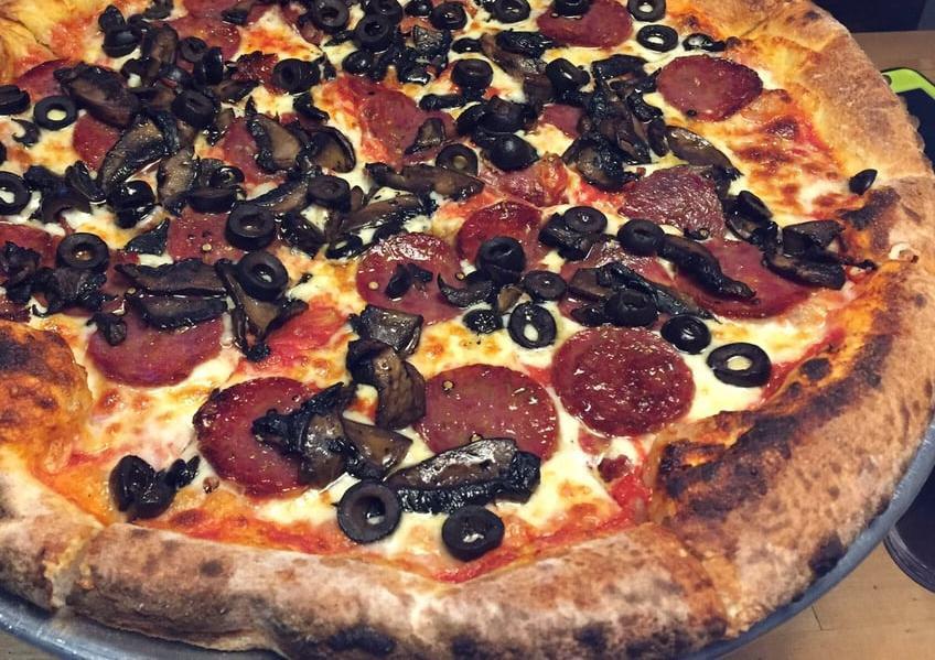 Capricosa Pizza · Salami, portobella, black olives, tomato sauce and grated mozzarella.