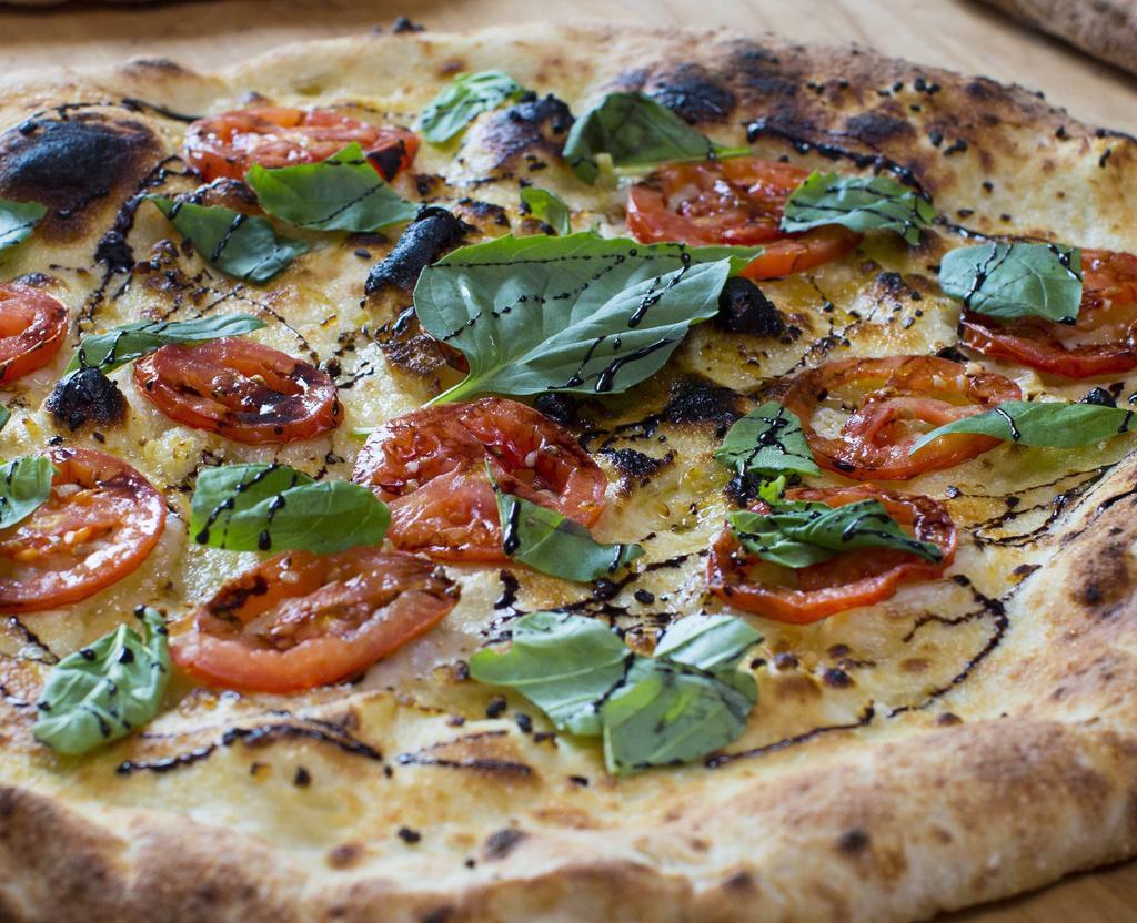 Caprese Pizza · Fresh mozzarella, Roma tomato, garlic olive oil, balsamic glaze basil and fresh basil.