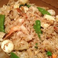 63. Classic Thai Fried Rice · Stir-fried jasmine rice with scallops, prawns, calamari, pineapple, egg, and diced fresh veg...
