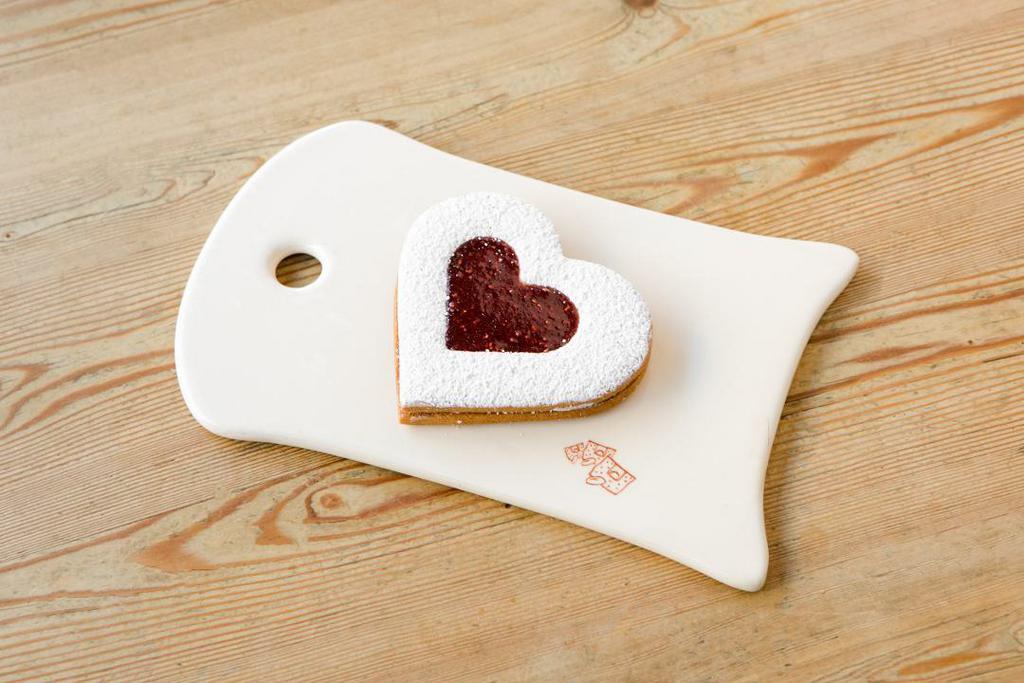 Heart Linzer · Heart shaped butter cookies with a scrumptious layer of berry jam and dusted with powered sugar

*Allergens: Egg, Milk, Wheat