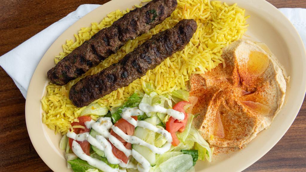 2. Kofta Kabob · 2 grilled pieces of lean ground beef mixed with fresh parsley onion and spices. Served with homemade hummus, rice, house salad, pita bread and our famous green hot sauce.